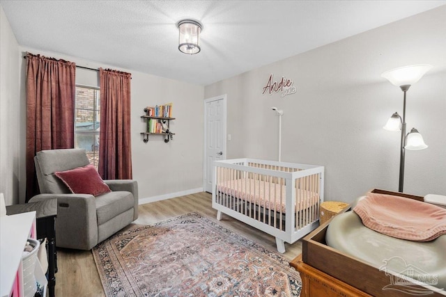 4308 Northpointe Way, Pensacola, FL 32514 - bedroom with wood finished floors, baseboards, and a crib