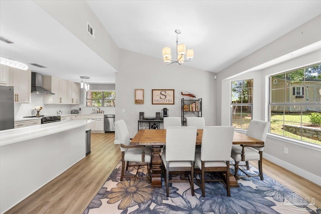 4308 Northpointe Way, Pensacola, FL 32514 - dining space featuring vaulted ceiling, light wood-style floors, a chandelier, and baseboards