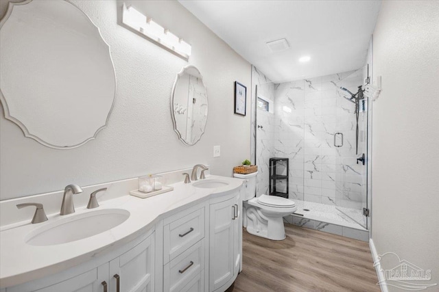 4308 Northpointe Way, Pensacola, FL 32514 - bathroom featuring toilet, a marble finish shower, double vanity, and wood finished floors