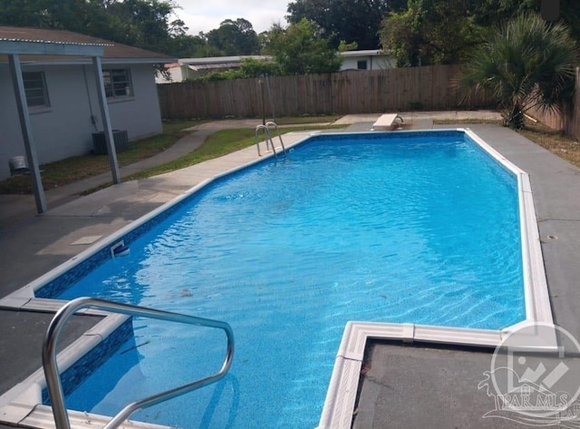 view of swimming pool featuring central air condition unit