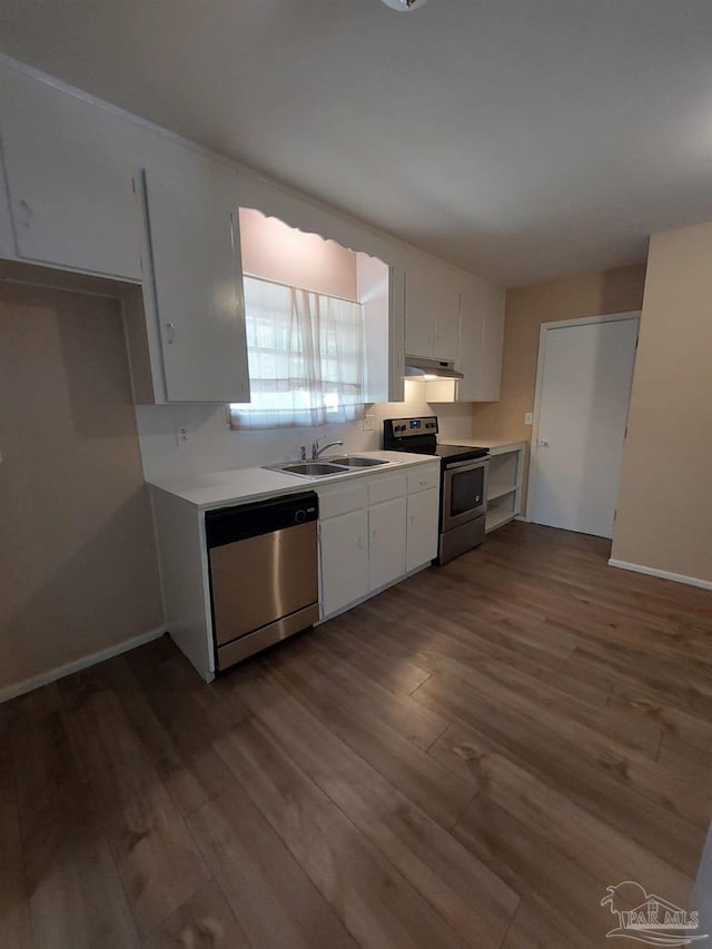 kitchen featuring appliances with stainless steel finishes, dark hardwood / wood-style floors, sink, and white cabinets