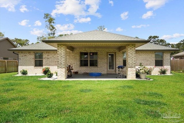 rear view of house featuring brick siding, a patio area, and a shingled roof
