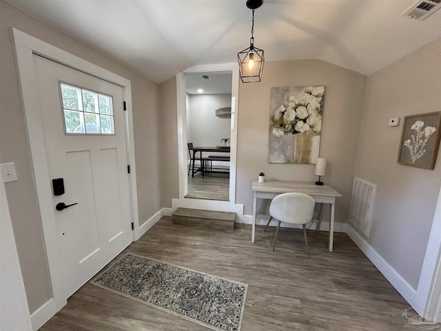 entryway with dark hardwood / wood-style floors and lofted ceiling