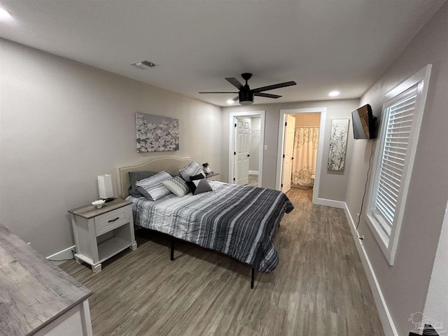 bedroom with ceiling fan, hardwood / wood-style floors, and ensuite bathroom