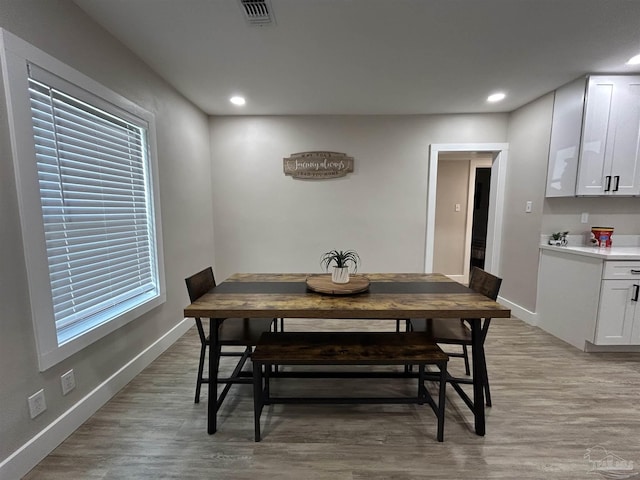 dining room with light wood-type flooring and plenty of natural light