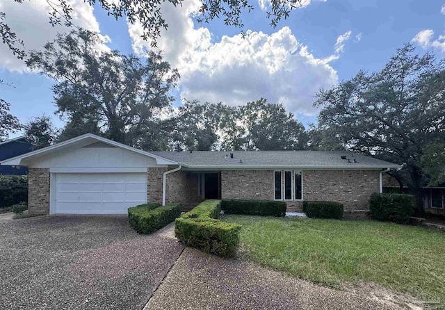 ranch-style house with a garage and a front yard