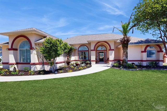 view of front facade featuring stucco siding, a front lawn, and roof with shingles