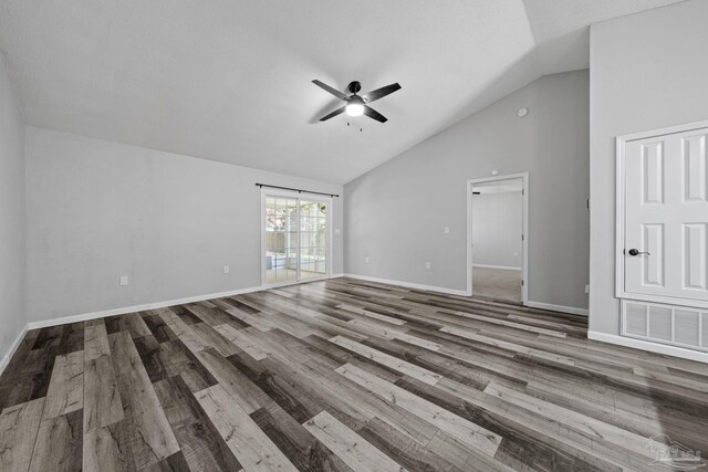 unfurnished living room featuring vaulted ceiling, ceiling fan, hardwood / wood-style floors, and a textured ceiling