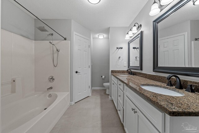 full bathroom featuring a textured ceiling, tiled shower / bath combo, vanity, and toilet