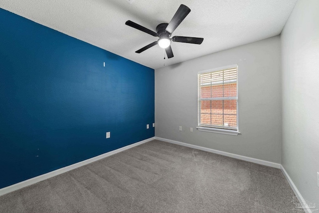 spare room featuring ceiling fan, carpet floors, and a textured ceiling