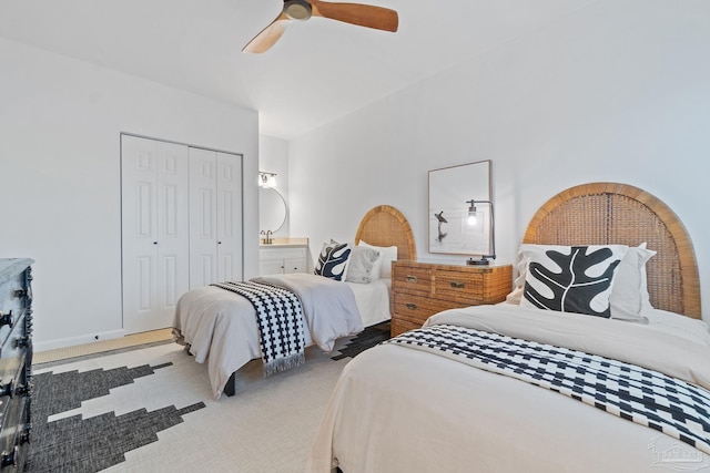 carpeted bedroom featuring a closet, ceiling fan, and baseboards