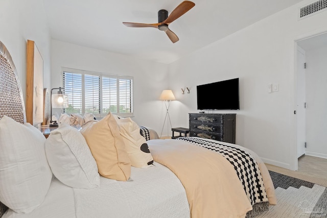 carpeted bedroom featuring a ceiling fan, visible vents, and baseboards