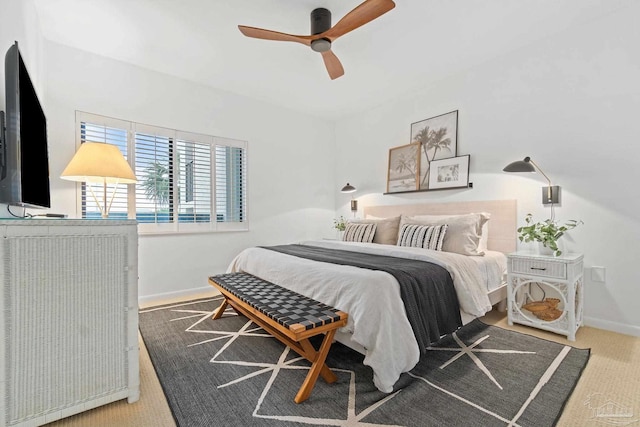 bedroom with ceiling fan, baseboards, and carpet flooring