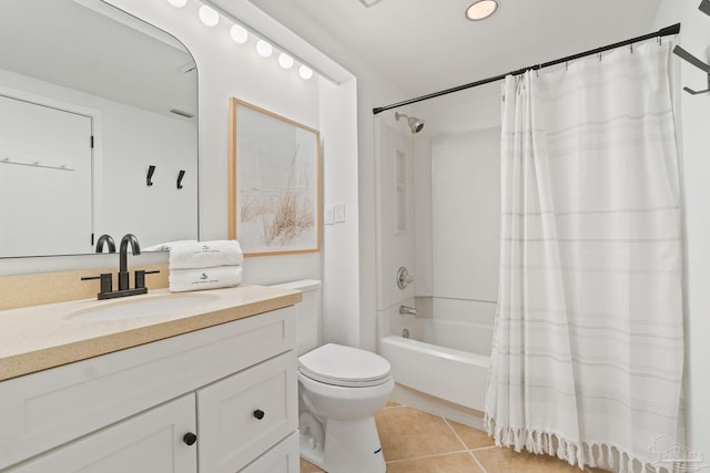 bathroom featuring toilet, vanity, tile patterned flooring, and shower / bath combo with shower curtain