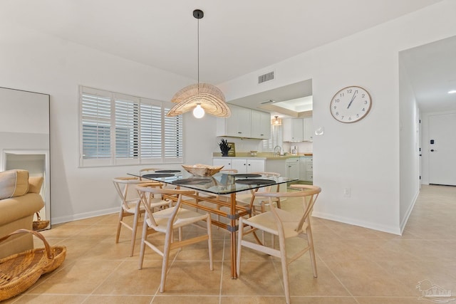 dining space with light tile patterned floors, visible vents, and baseboards