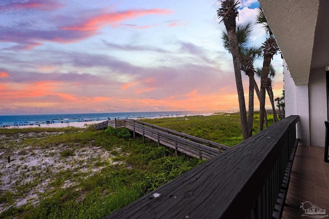 balcony featuring a water view and a view of the beach