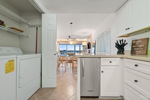 laundry room with laundry area, light tile patterned flooring, and washing machine and clothes dryer