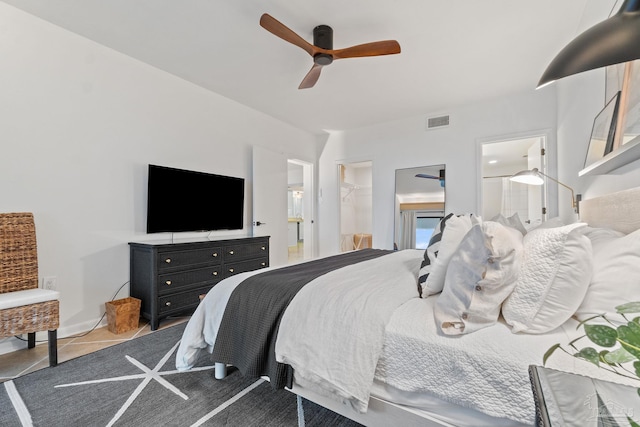 bedroom featuring visible vents, a ceiling fan, tile patterned flooring, a spacious closet, and a closet