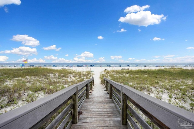 view of property's community featuring a beach view and a water view