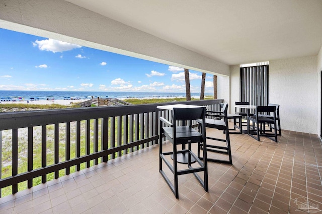 balcony with a view of the beach and a water view