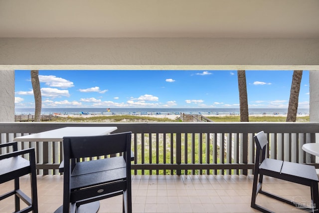 deck featuring a water view and a view of the beach