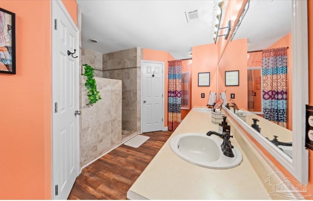 7837 Skyview Blvd, Navarre, FL 32566 - full bath with wood finished floors, a tile shower, and double vanity