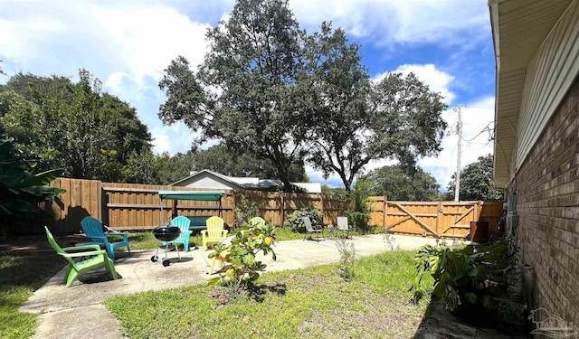 7837 Skyview Blvd, Navarre, FL 32566 - fenced backyard featuring a patio area and a gate