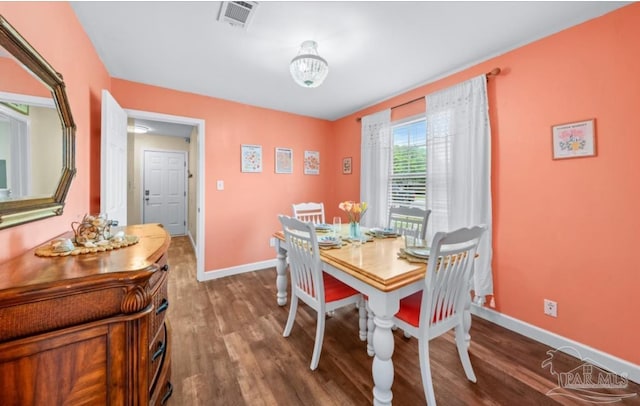 7837 Skyview Blvd, Navarre, FL 32566 - dining space featuring wood finished floors and a chandelier
