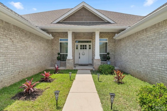 2849 Pga Blvd, Navarre, FL 32566 - property entrance featuring roof with shingles, brick siding, and a porch