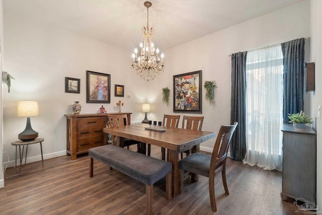 2849 Pga Blvd, Navarre, FL 32566 - dining room with dark wood-type flooring, baseboards, and a chandelier