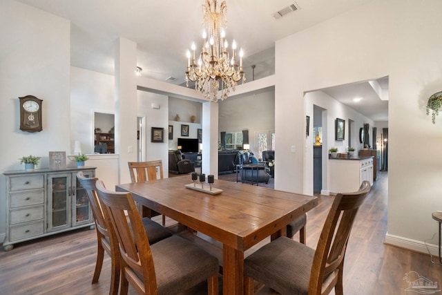 2849 Pga Blvd, Navarre, FL 32566 - dining area with dark wood finished floors, a chandelier, and a high ceiling