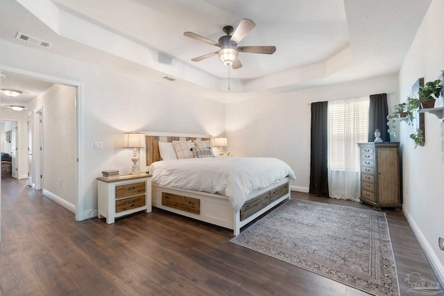 2849 Pga Blvd, Navarre, FL 32566 - bedroom featuring a raised ceiling, dark wood-style floors, baseboards, and a ceiling fan