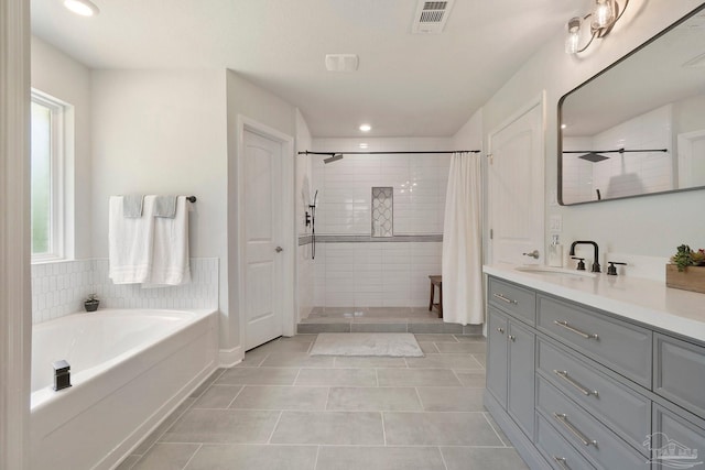 2849 Pga Blvd, Navarre, FL 32566 - bathroom featuring plenty of natural light, tile patterned flooring, tiled shower, recessed lighting, and vanity