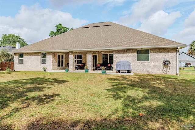 2849 Pga Blvd, Navarre, FL 32566 - back of house featuring a shingled roof, a patio, ceiling fan, and a yard