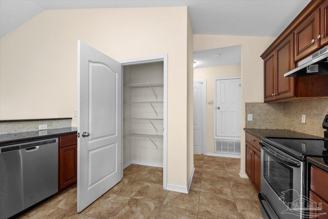 4361 Martha Ct, Gulf Breeze, FL 32562 - kitchen with lofted ceiling, dark stone countertops, tasteful backsplash, appliances with stainless steel finishes, and light tile patterned flooring