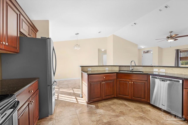 4361 Martha Ct, Gulf Breeze, FL 32562 - kitchen with appliances with stainless steel finishes, decorative light fixtures, vaulted ceiling, sink, and dark stone countertops