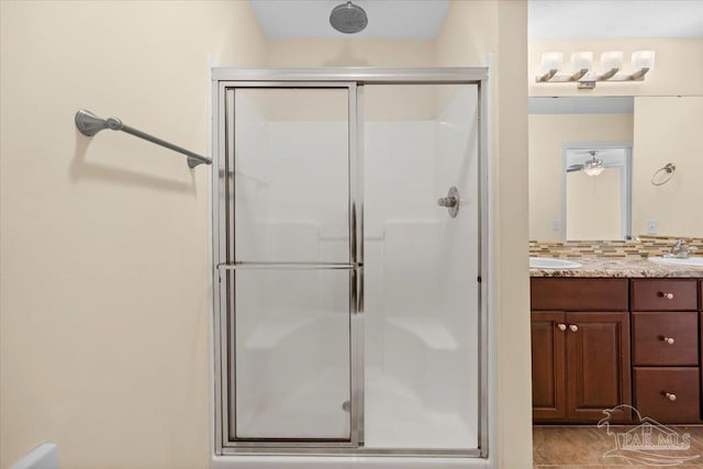 4361 Martha Ct, Gulf Breeze, FL 32562 - bathroom featuring decorative backsplash, vanity, and a shower with shower door