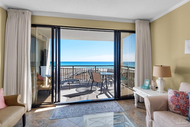 interior space with a textured ceiling, ornamental molding, and a water view