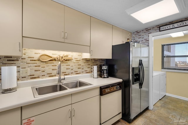 kitchen featuring separate washer and dryer, decorative backsplash, sink, stainless steel fridge with ice dispenser, and white dishwasher