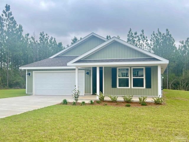 9344 Three Hollow Rd, Jay, FL 32565 - view of front of home with a porch, an attached garage, concrete driveway, and a front yard