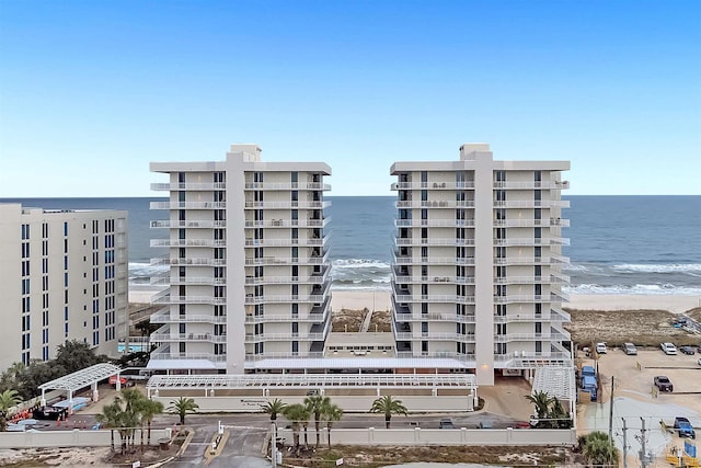 view of building exterior featuring a view of the beach and a water view