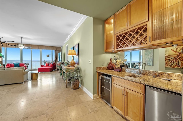 bar featuring sink, fridge, light stone countertops, ornamental molding, and beverage cooler