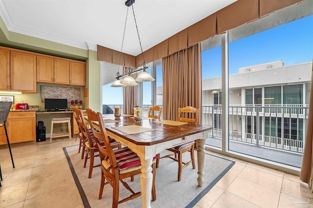 dining area featuring light tile patterned floors and ornamental molding