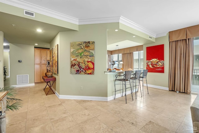 kitchen featuring crown molding, a breakfast bar, light tile patterned flooring, and kitchen peninsula
