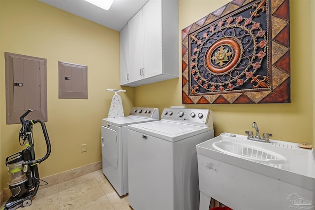 washroom with cabinets, washer and dryer, sink, and electric panel