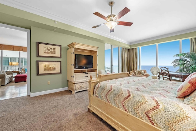 carpeted bedroom featuring crown molding and ceiling fan