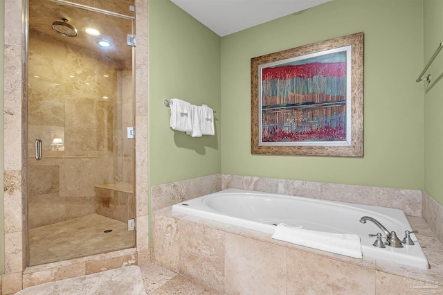 bathroom featuring independent shower and bath