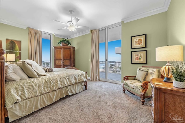 bedroom with crown molding, carpet floors, access to outside, and a wall of windows