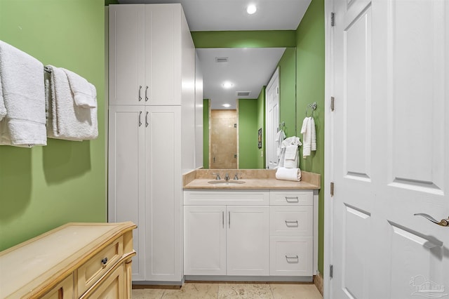 bathroom with walk in shower and vanity