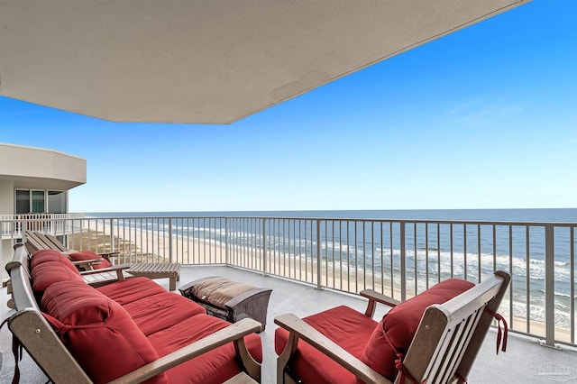 balcony featuring a beach view and a water view